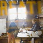 View through door of entrepreneurs working in office